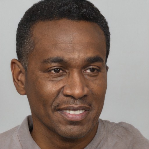 Joyful latino adult male with short  brown hair and brown eyes