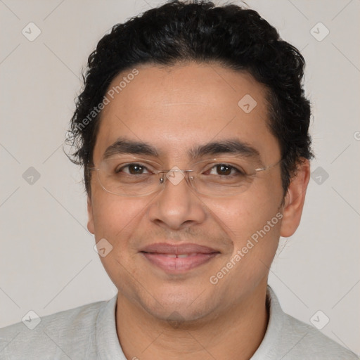 Joyful latino adult male with short  brown hair and brown eyes