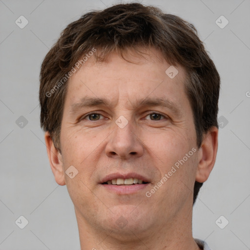 Joyful white adult male with short  brown hair and brown eyes