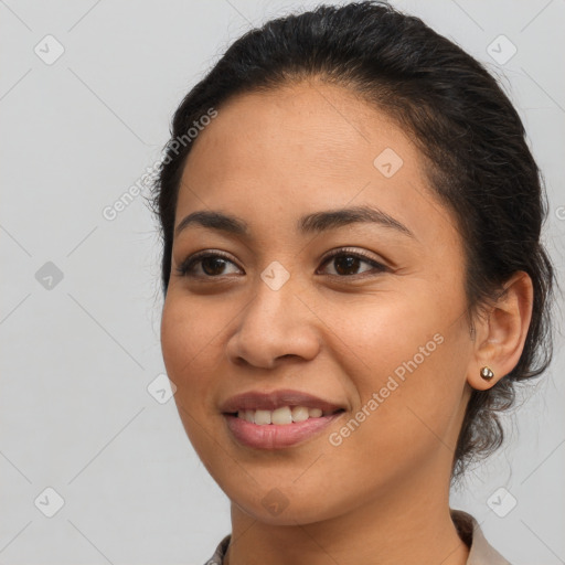 Joyful latino young-adult female with medium  brown hair and brown eyes