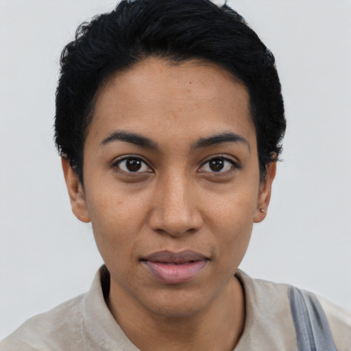 Joyful latino young-adult female with short  black hair and brown eyes