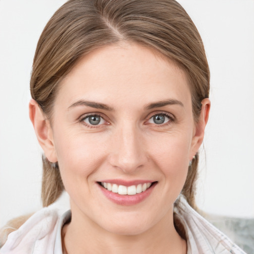 Joyful white young-adult female with medium  brown hair and blue eyes