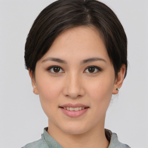 Joyful asian young-adult female with short  brown hair and brown eyes
