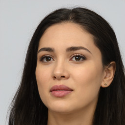 Joyful latino young-adult female with long  brown hair and brown eyes