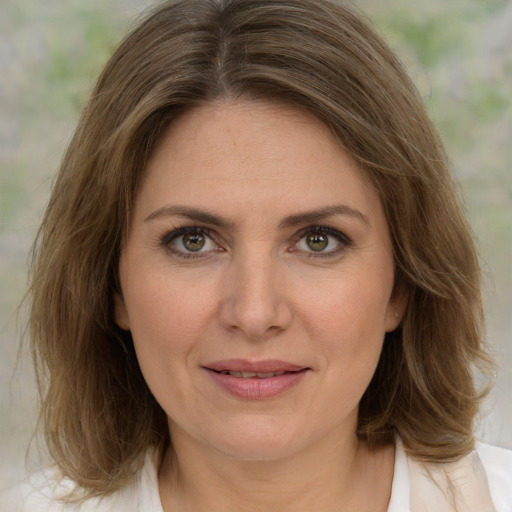 Joyful white young-adult female with medium  brown hair and green eyes