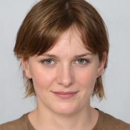 Joyful white young-adult female with medium  brown hair and blue eyes