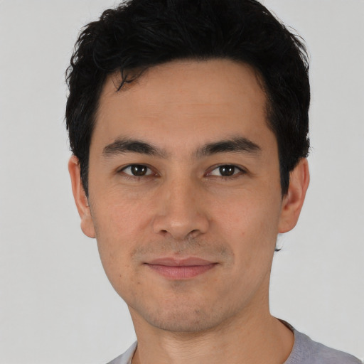 Joyful asian young-adult male with short  black hair and brown eyes