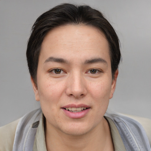 Joyful asian young-adult female with short  brown hair and brown eyes