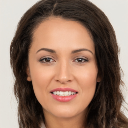 Joyful white young-adult female with long  brown hair and brown eyes