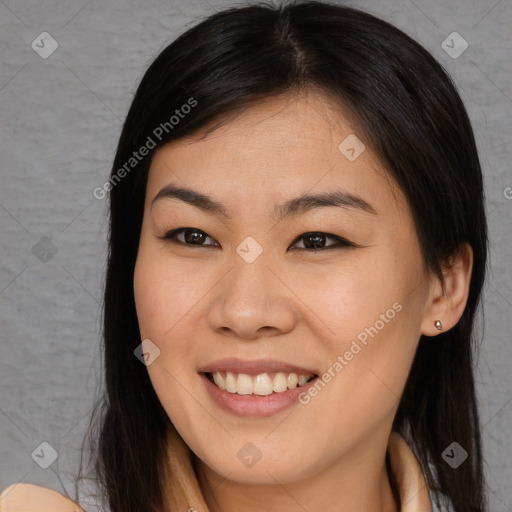 Joyful asian young-adult female with long  brown hair and brown eyes