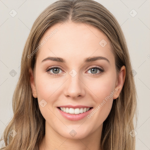 Joyful white young-adult female with long  brown hair and green eyes