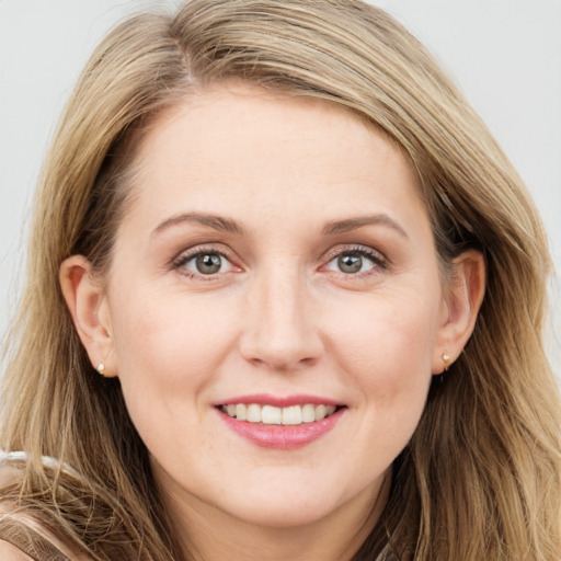 Joyful white young-adult female with long  brown hair and blue eyes