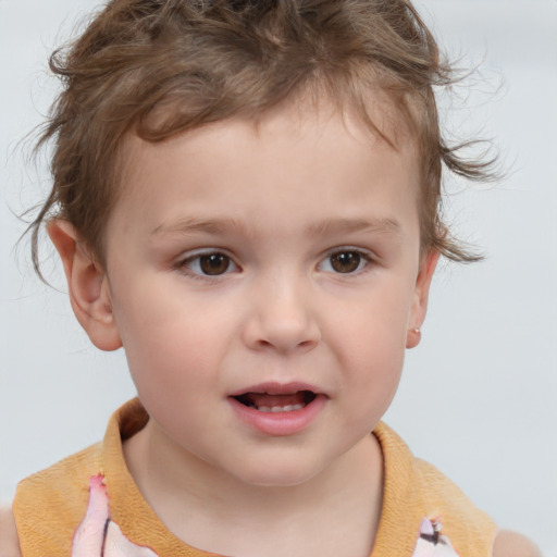 Joyful white child male with medium  brown hair and brown eyes