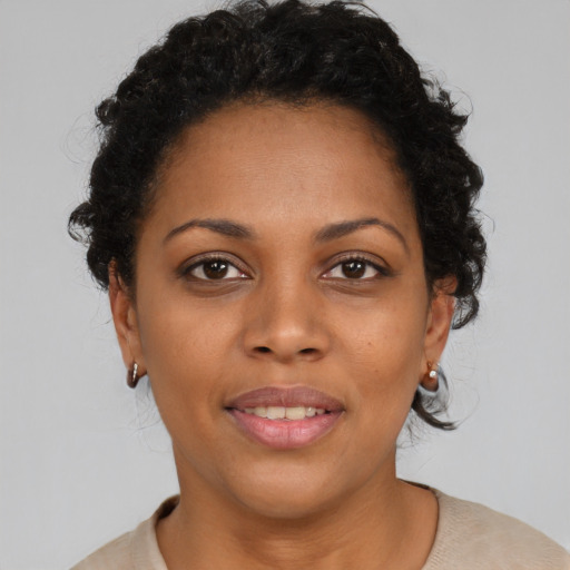 Joyful black young-adult female with short  brown hair and brown eyes