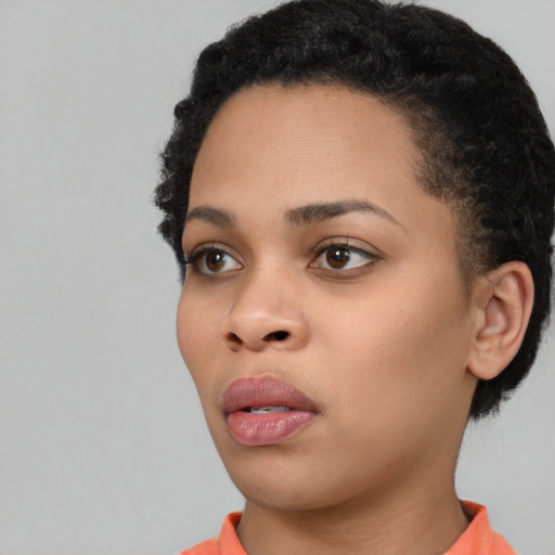 Neutral black young-adult female with short  black hair and brown eyes