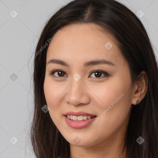 Joyful white young-adult female with long  brown hair and brown eyes