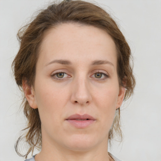 Joyful white young-adult female with medium  brown hair and green eyes