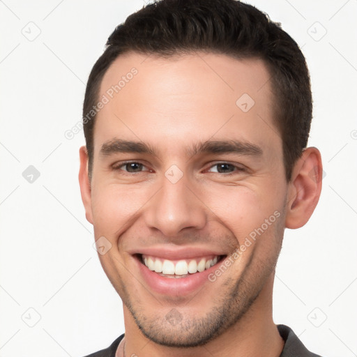 Joyful white young-adult male with short  brown hair and brown eyes