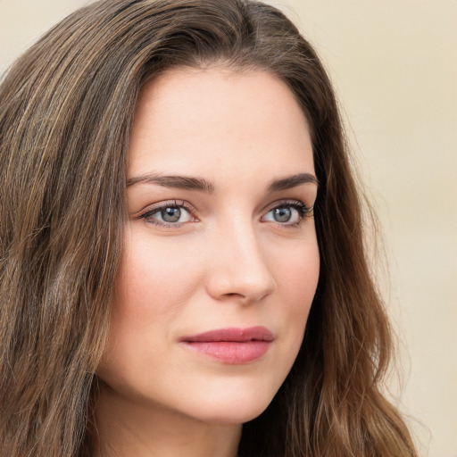 Joyful white young-adult female with long  brown hair and green eyes