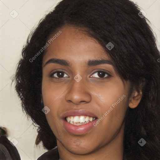 Joyful black young-adult female with long  black hair and brown eyes