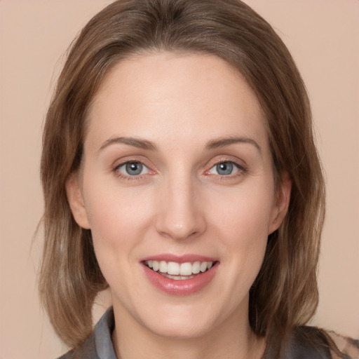 Joyful white young-adult female with medium  brown hair and grey eyes