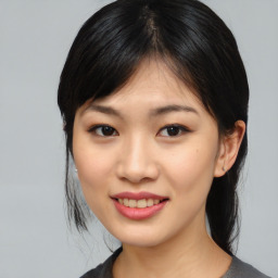 Joyful asian young-adult female with medium  black hair and brown eyes