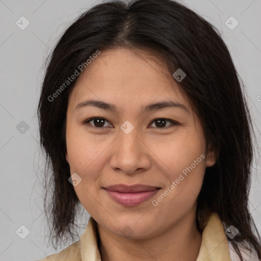 Joyful latino adult female with medium  brown hair and brown eyes