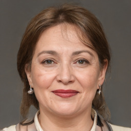 Joyful white adult female with medium  brown hair and brown eyes