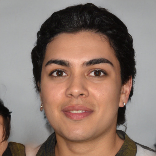Joyful white young-adult male with medium  black hair and brown eyes