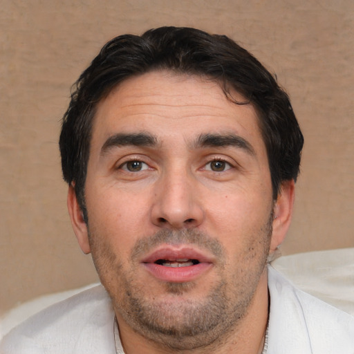 Joyful white adult male with short  brown hair and brown eyes