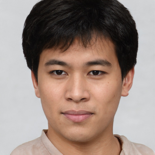 Joyful asian young-adult male with short  brown hair and brown eyes
