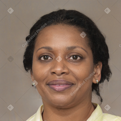 Joyful black adult female with medium  brown hair and brown eyes