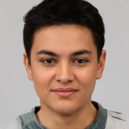 Joyful latino young-adult male with short  black hair and brown eyes