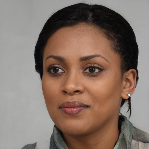 Joyful black young-adult female with medium  black hair and brown eyes