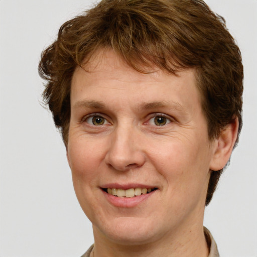 Joyful white adult male with short  brown hair and green eyes