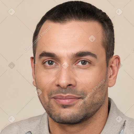 Joyful white young-adult male with short  black hair and brown eyes