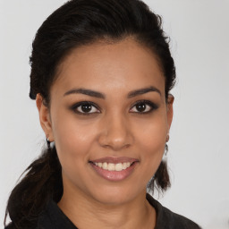 Joyful latino young-adult female with medium  brown hair and brown eyes