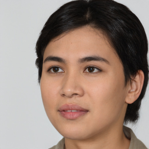 Joyful asian young-adult female with medium  black hair and brown eyes
