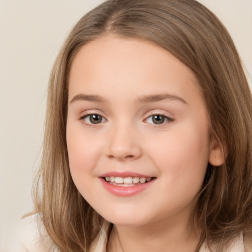 Joyful white child female with long  brown hair and brown eyes