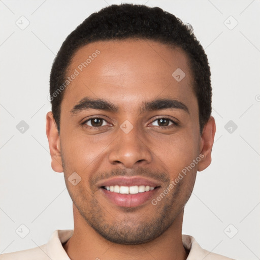 Joyful black young-adult male with short  brown hair and brown eyes