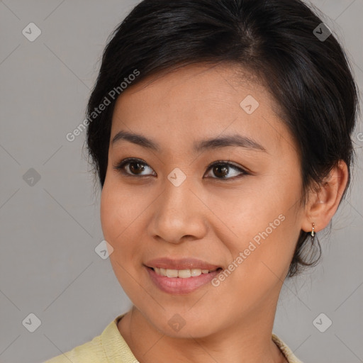 Joyful asian young-adult female with medium  brown hair and brown eyes