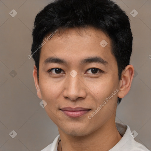 Joyful asian young-adult male with short  black hair and brown eyes