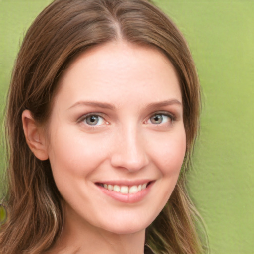 Joyful white young-adult female with long  brown hair and green eyes