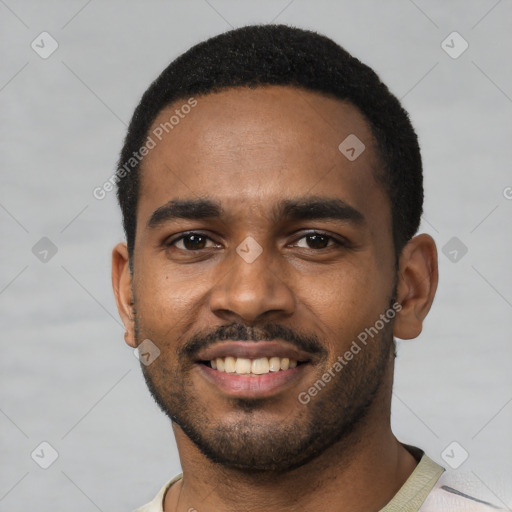 Joyful black young-adult male with short  black hair and brown eyes
