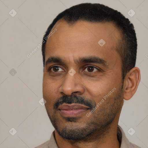 Joyful black adult male with short  black hair and brown eyes