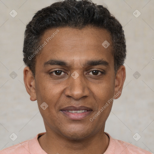 Joyful black adult male with short  black hair and brown eyes