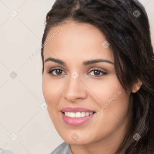 Joyful white young-adult female with long  black hair and brown eyes