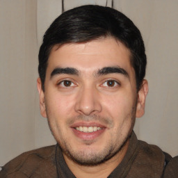 Joyful white young-adult male with short  black hair and brown eyes