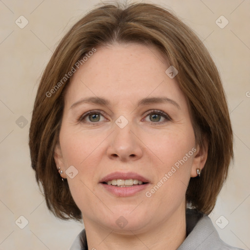 Joyful white adult female with medium  brown hair and grey eyes