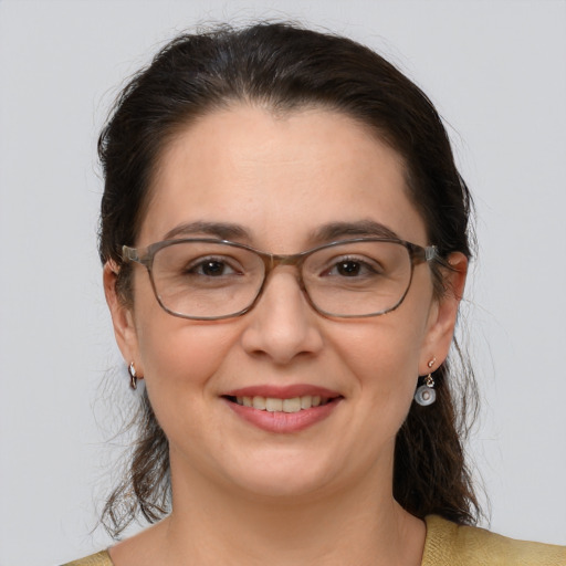 Joyful white adult female with medium  brown hair and grey eyes